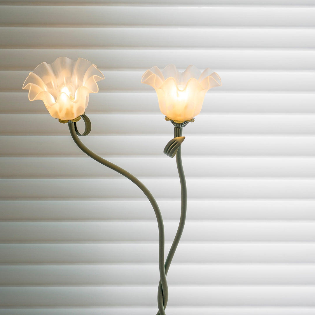 Elegant green floor lamp with white calla flower accents, matte finish, and metal construction, enhancing home decor.