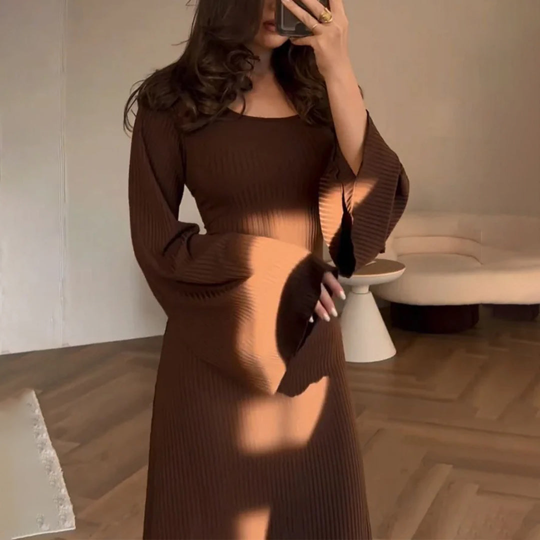 Elegant knit maxi dress with long sleeves in solid brown, featuring a round neckline and wide sleeves for a chic look.