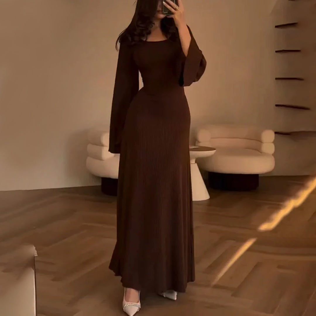 Elegant knit maxi dress with long sleeves in solid brown, featuring a round neckline and wide sleeves for a chic look.