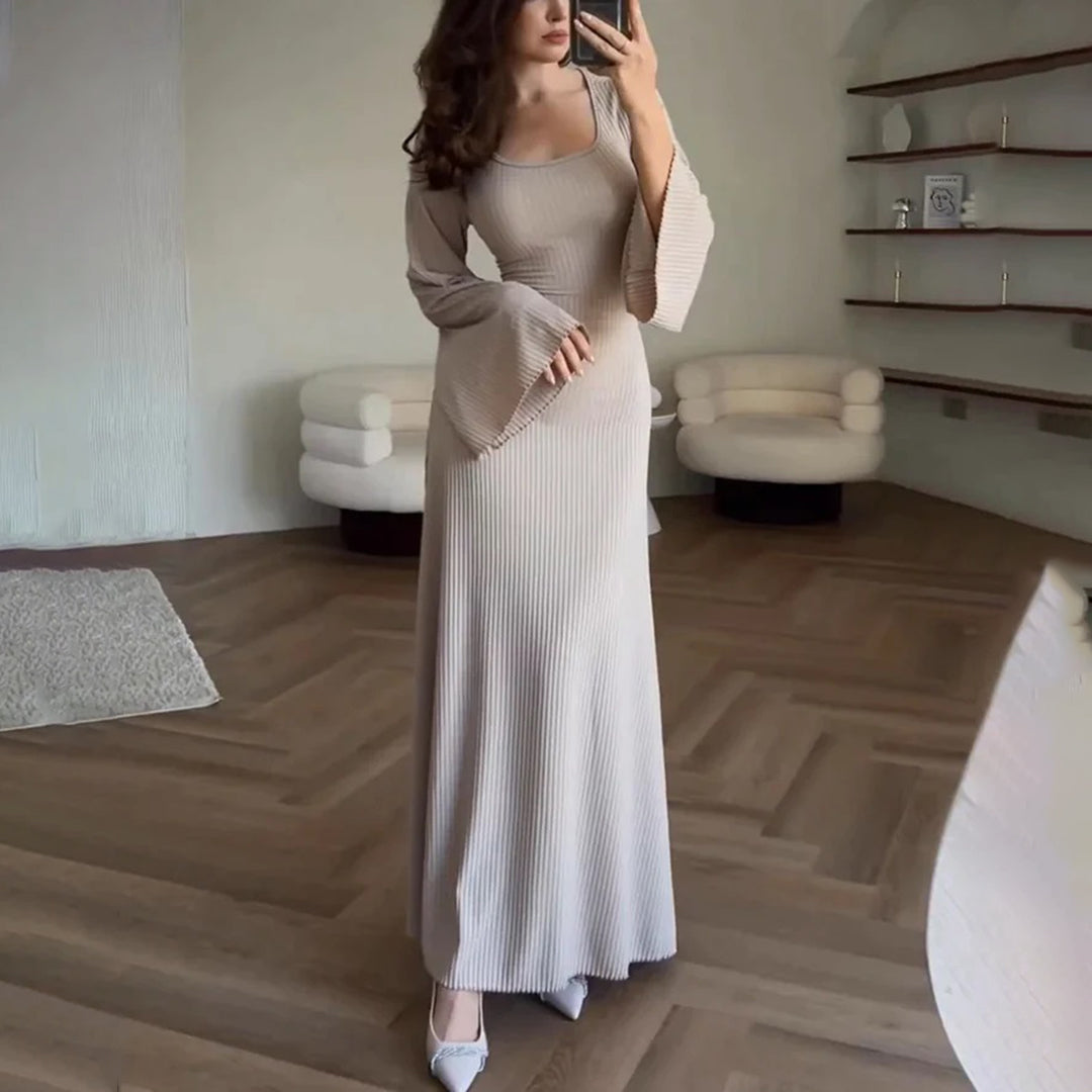 Elegant knit maxi dress with long sleeves in solid brown, featuring a round neckline and wide sleeves for a chic look.