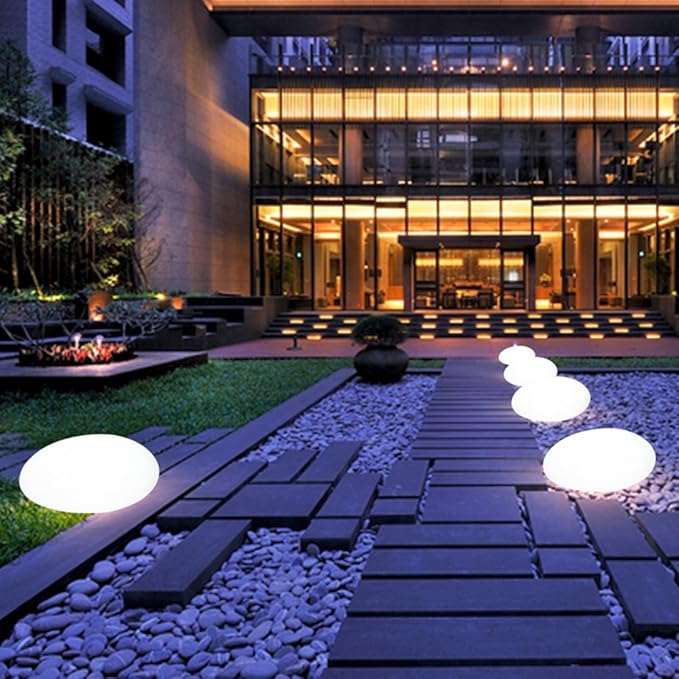 Elegant LED garden light with cobblestone design, glowing in multiple colors, ideal for illuminating outdoor spaces like gard