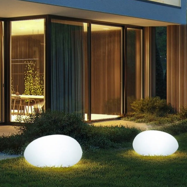 Elegant LED garden light with cobblestone design, glowing in multiple colors, ideal for illuminating outdoor spaces like gard