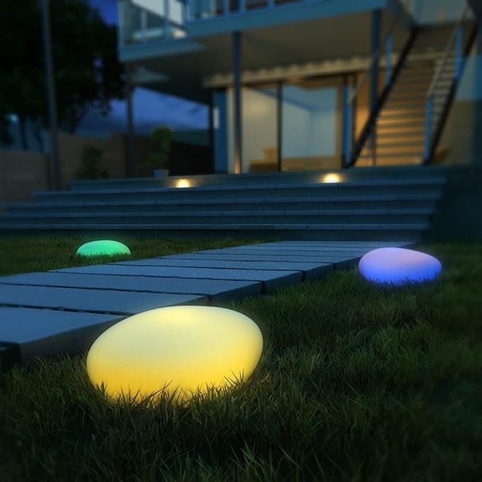 Elegant LED garden light with cobblestone design, glowing in multiple colors, ideal for illuminating outdoor spaces like gard