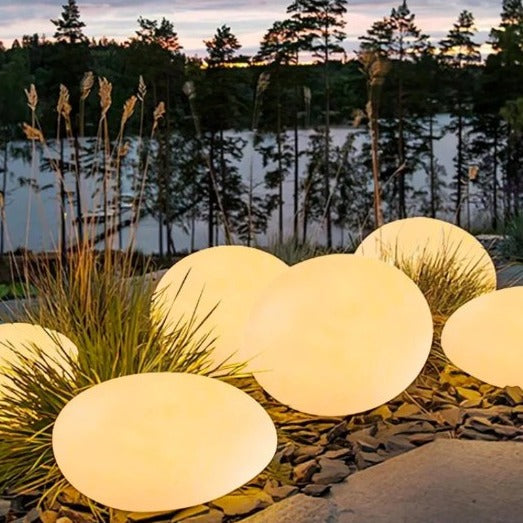 Elegant LED garden light with cobblestone design, glowing in multiple colors, ideal for illuminating outdoor spaces like gard