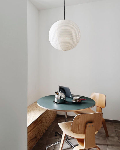 "Elegant modern Japanese paper lantern pendant light with a warm glow, blending contemporary and mid-century design."