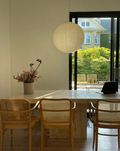 "Elegant modern Japanese paper lantern pendant light with a warm glow, blending contemporary and mid-century design."
