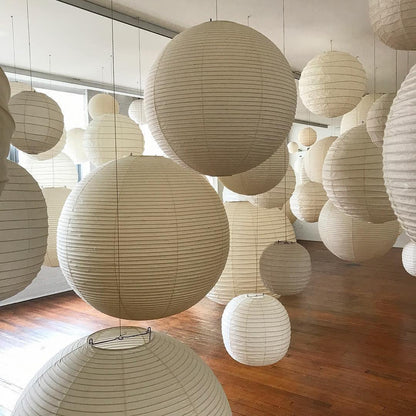 "Elegant modern Japanese paper lantern pendant light with a warm glow, blending contemporary and mid-century design."