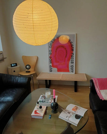 "Elegant modern Japanese paper lantern pendant light with a warm glow, blending contemporary and mid-century design."