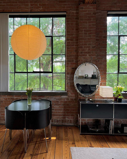 "Elegant modern Japanese paper lantern pendant light with a warm glow, blending contemporary and mid-century design."