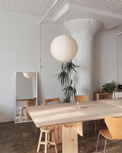 "Elegant modern Japanese paper lantern pendant light with a warm glow, blending contemporary and mid-century design."