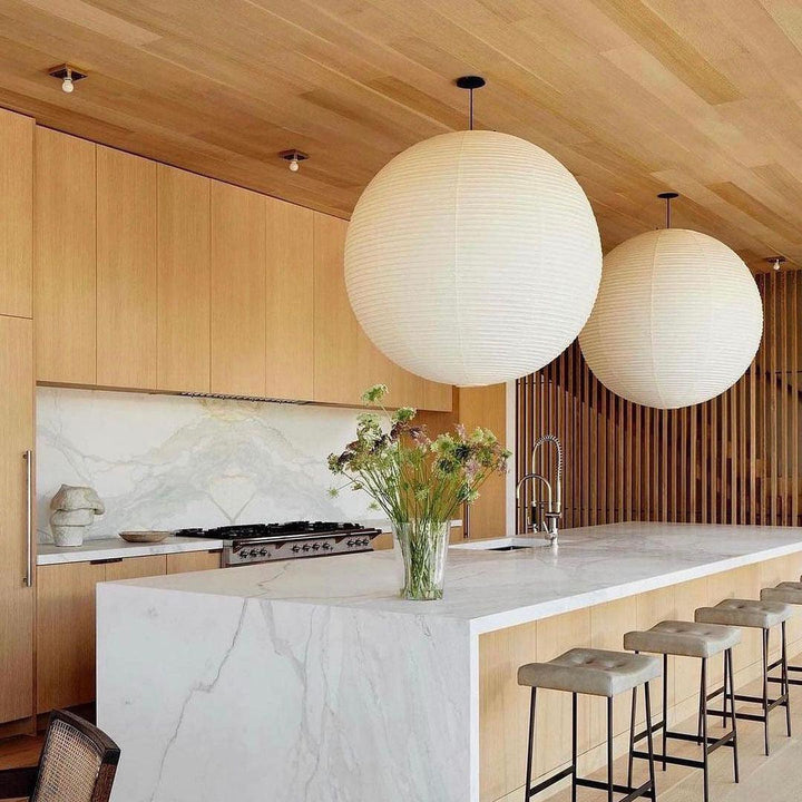 "Elegant modern Japanese paper lantern pendant light with a warm glow, blending contemporary and mid-century design."