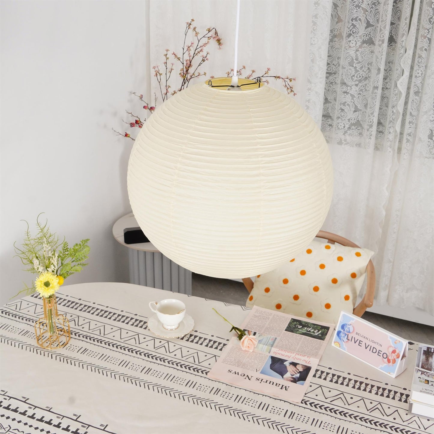 "Elegant modern Japanese paper lantern pendant light with a warm glow, blending contemporary and mid-century design."