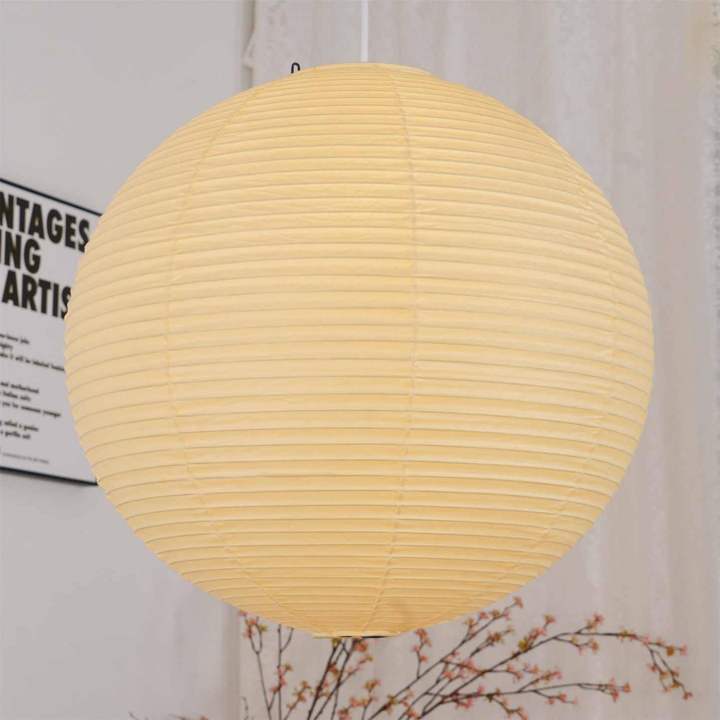 "Elegant modern Japanese paper lantern pendant light with a warm glow, blending contemporary and mid-century design."