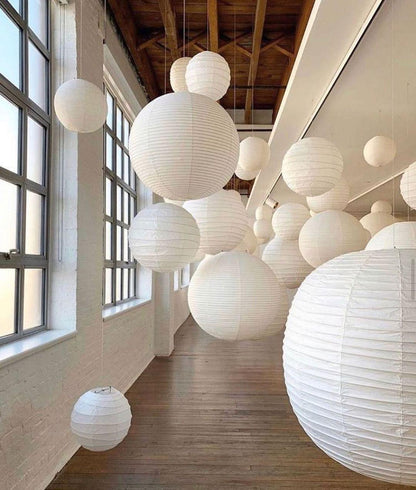 "Elegant modern Japanese paper lantern pendant light with a warm glow, blending contemporary and mid-century design."