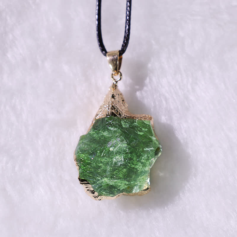 Elegant Moldavite necklace with unique design, featuring a green gemstone. Perfect for adding sophistication to any outfit.