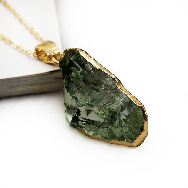 Elegant Moldavite necklace with unique design, featuring a green gemstone. Perfect for adding sophistication to any outfit.