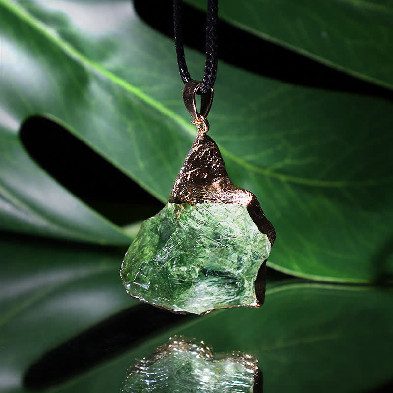 Elegant Moldavite necklace with unique design, featuring a green gemstone. Perfect for adding sophistication to any outfit.
