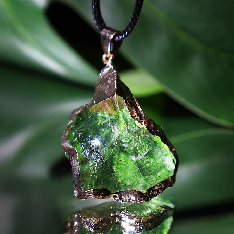 Elegant Moldavite necklace with unique design, featuring a green gemstone. Perfect for adding sophistication to any outfit.