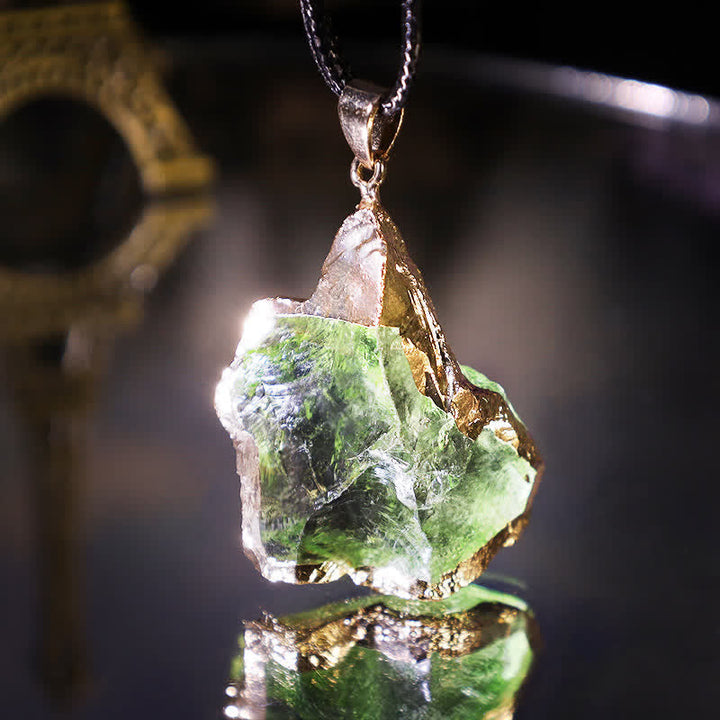 Elegant Moldavite necklace with unique design, featuring a green gemstone. Perfect for adding sophistication to any outfit.