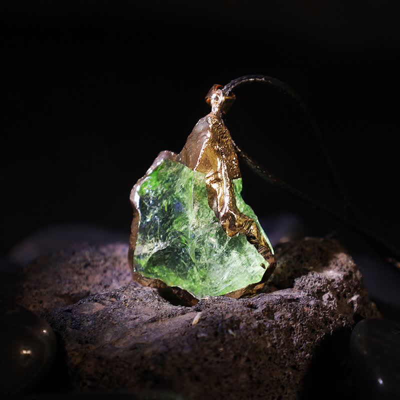 Elegant Moldavite necklace with unique design, featuring a green gemstone. Perfect for adding sophistication to any outfit.