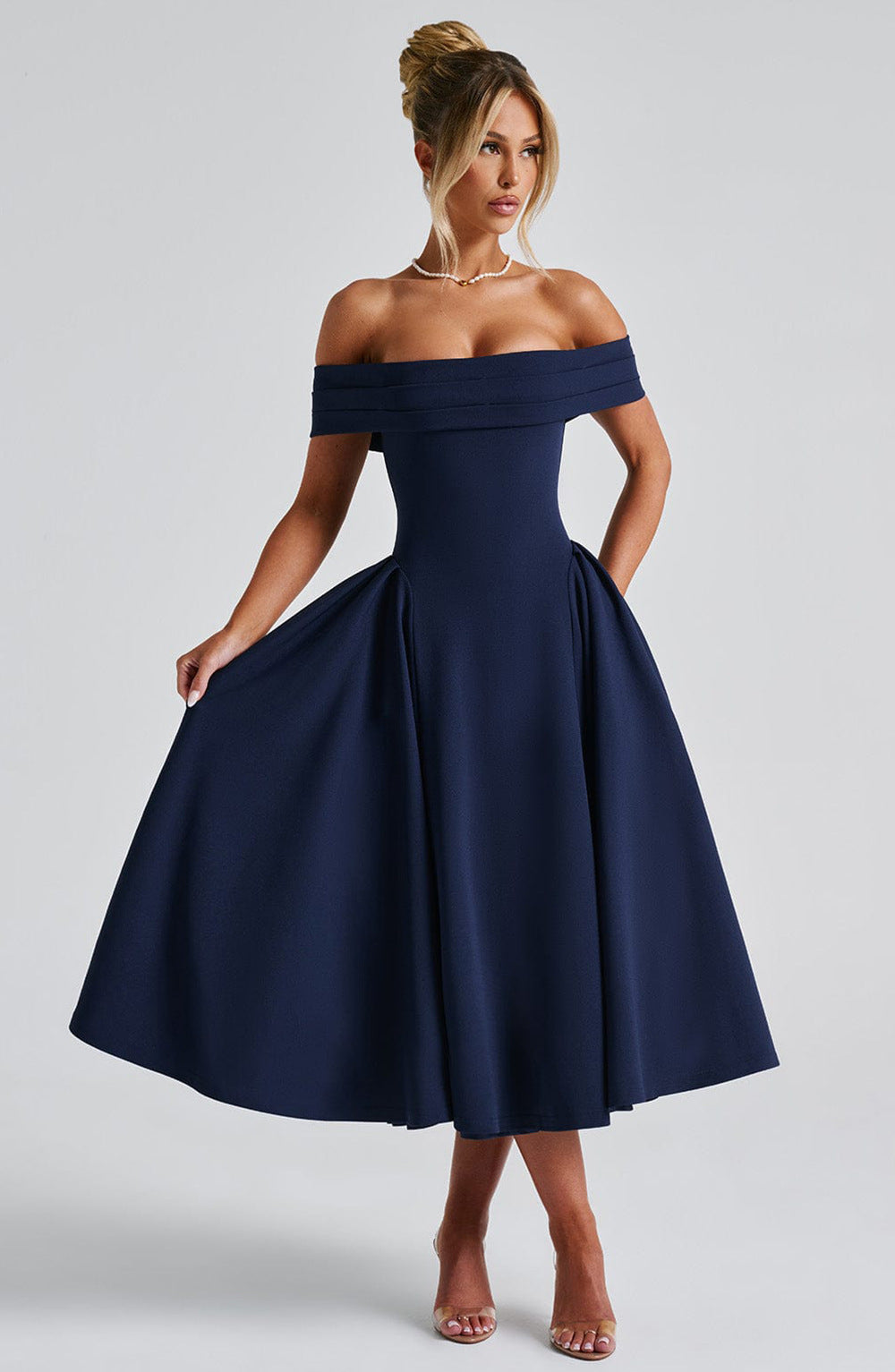 Elegant off-shoulder A-line midi dress in classic colors, designed to highlight graceful silhouettes for formal events.