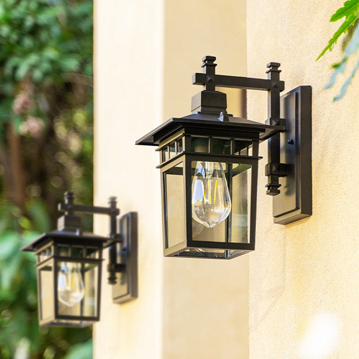 "Elegant outdoor waterproof lantern wall light with black finish and glass shade, perfect for gardens and porches."