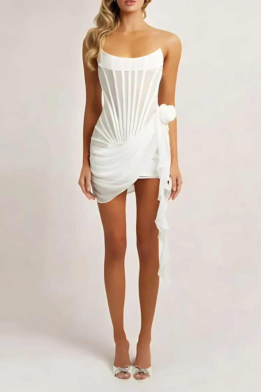 "Elegant strapless sheer mini dress with boned corset, showcasing a flattering silhouette and exquisite draped detailing."