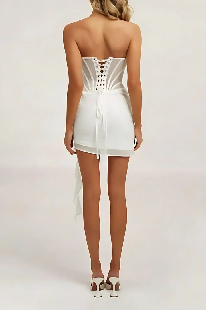 "Elegant strapless sheer mini dress with boned corset, showcasing a flattering silhouette and exquisite draped detailing."