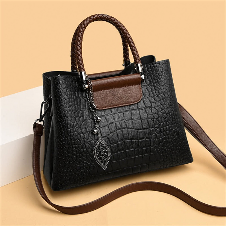 Elegant teak women's handbag with luxe design, showcasing premium craftsmanship and spacious interior in classic colors.