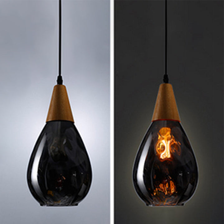 "Elegant teardrop glass pendant light with wood accents, available in clear, golden, smoky gray, perfect for any home decor."