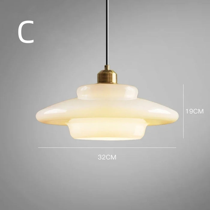Elegant white glass pendant light with brass fixture, mid-century design, perfect for modern or classic interiors, adds luxur
