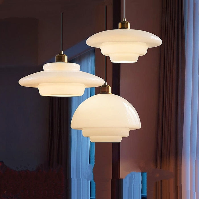 Elegant white glass pendant light with brass fixture, mid-century design, perfect for modern or classic interiors, adds luxur
