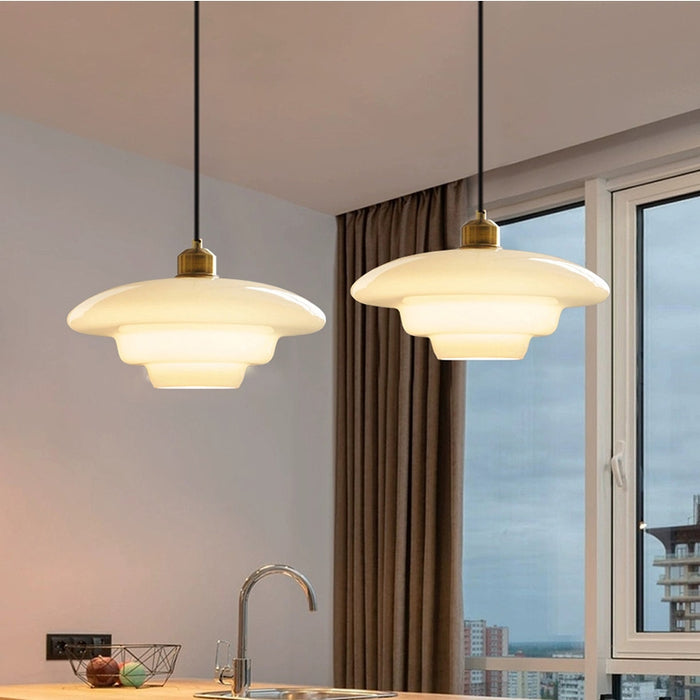 Elegant white glass pendant light with brass fixture, mid-century design, perfect for modern or classic interiors, adds luxur