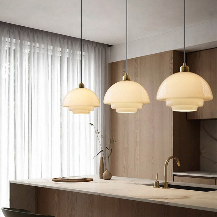 Elegant white glass pendant light with brass fixture, mid-century design, perfect for modern or classic interiors, adds luxur