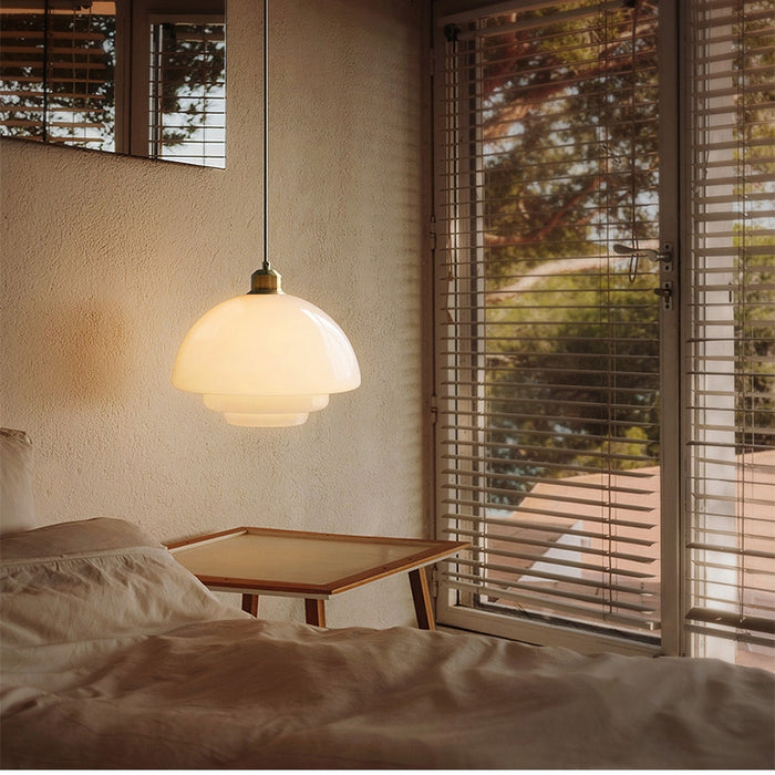 Elegant white glass pendant light with brass fixture, mid-century design, perfect for modern or classic interiors, adds luxur
