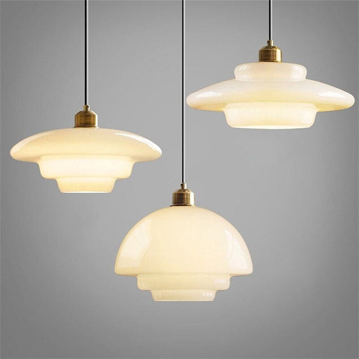 Elegant white glass pendant light with brass fixture, mid-century design, perfect for modern or classic interiors, adds luxur