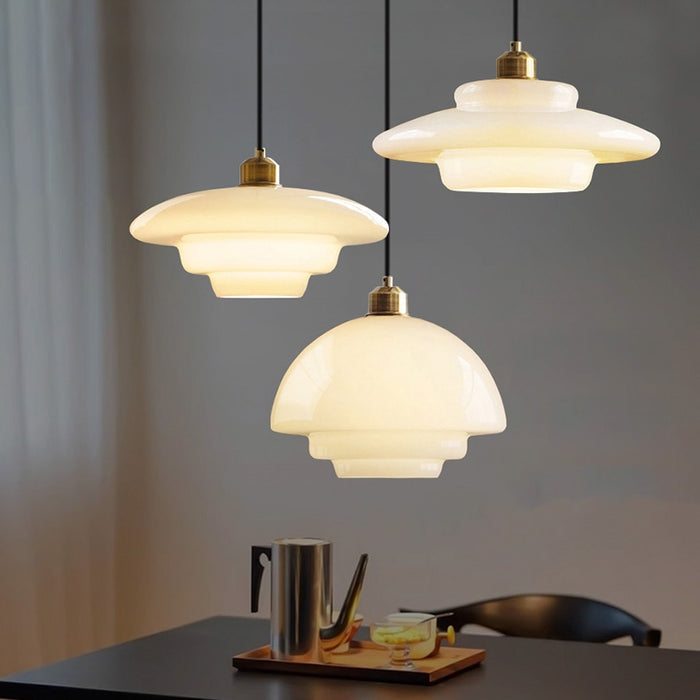 Elegant white glass pendant light with brass fixture, mid-century design, perfect for modern or classic interiors, adds luxur