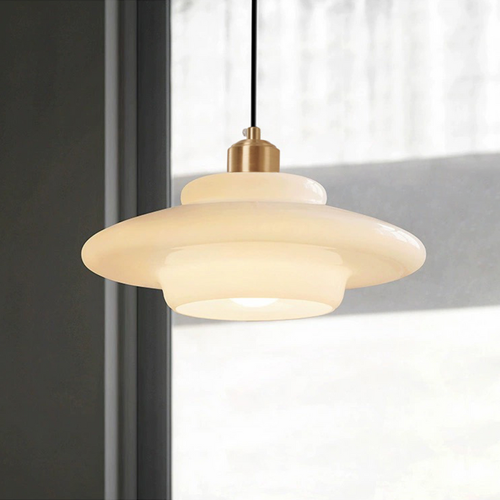 Elegant white glass pendant light with brass fixture, mid-century design, perfect for modern or classic interiors, adds luxur