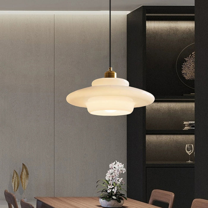Elegant white glass pendant light with brass fixture, mid-century design, perfect for modern or classic interiors, adds luxur