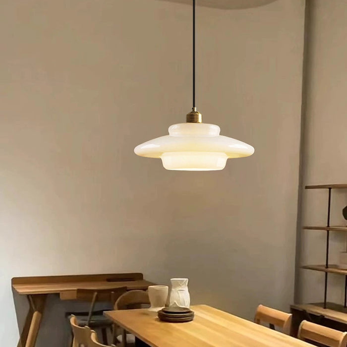 Elegant white glass pendant light with brass fixture, mid-century design, perfect for modern or classic interiors, adds luxur
