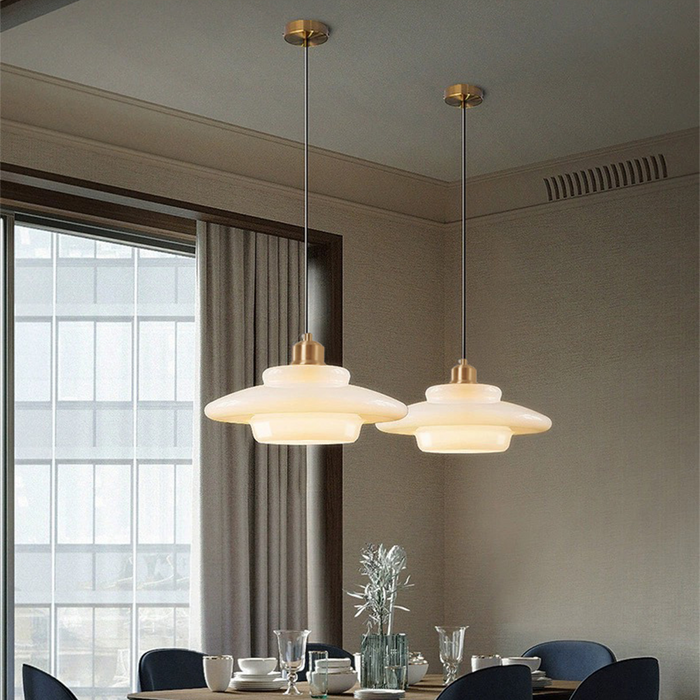 Elegant white glass pendant light with brass fixture, mid-century design, perfect for modern or classic interiors, adds luxur