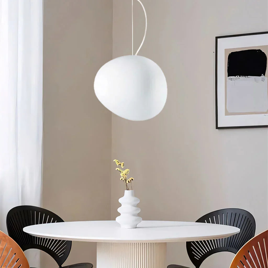 Elegant white pebble pendant light; minimal design, frosted glass, metal accents, soft glow for modern interiors.