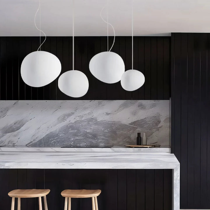 Elegant white pebble pendant light; minimal design, frosted glass, metal accents, soft glow for modern interiors.