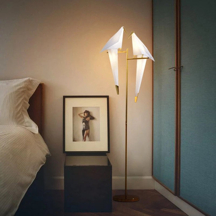"Elegant wireless origami bird lamp with magnetic attachment emitting warm light; enhances home decor with artistic design."