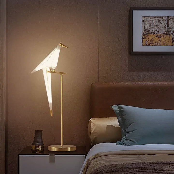 "Elegant wireless origami bird lamp with magnetic attachment emitting warm light; enhances home decor with artistic design."
