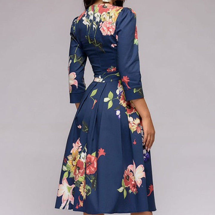 Elegant women's A-line knee-length dress with vibrant floral print, fitted waist, 3/4 sleeves, perfect for spring occasions.