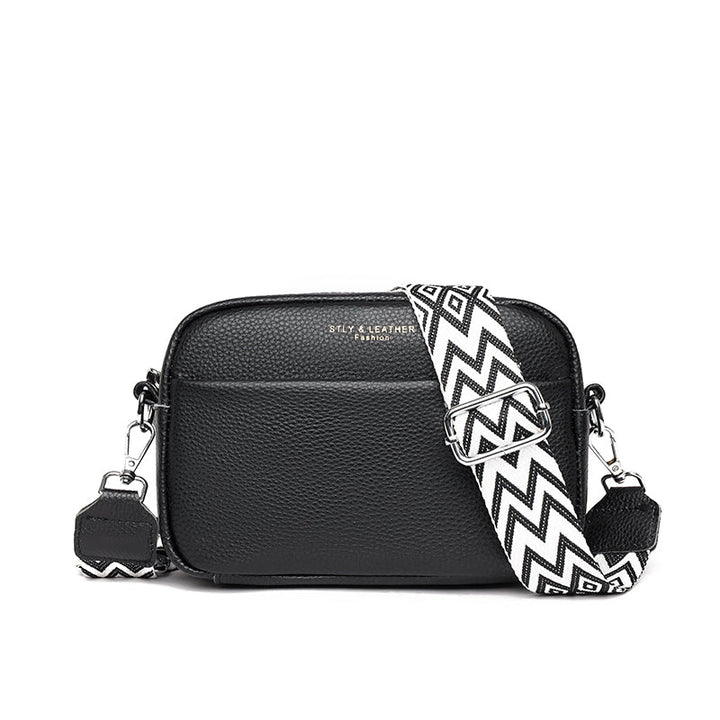 Elegant women's leather crossbody bag with adjustable strap, pebbled texture, ideal for casual or formal occasions.