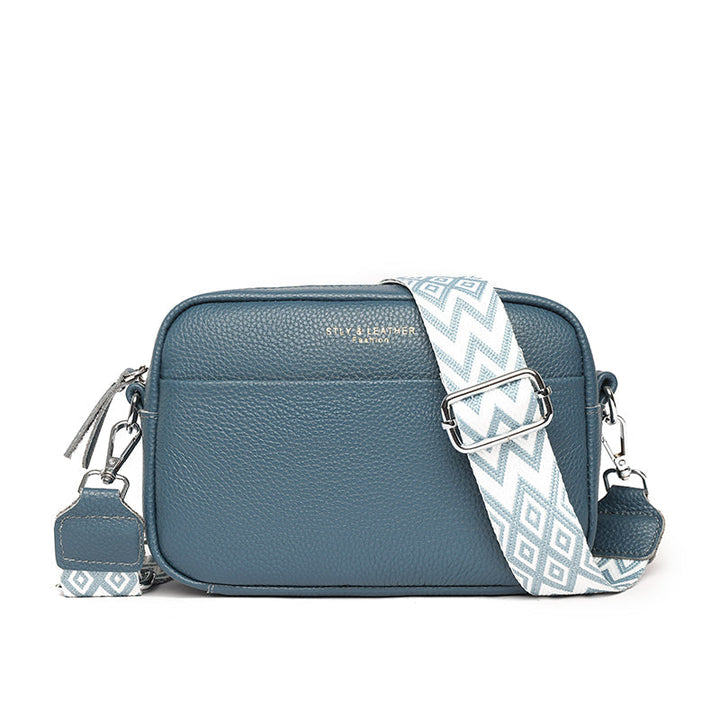 Elegant women's leather crossbody bag with adjustable strap, pebbled texture, ideal for casual or formal occasions.