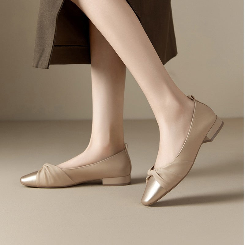Elegant women's low heel shoes in soft leather with chic pointed toe and twisted strap design, perfect for any occasion.