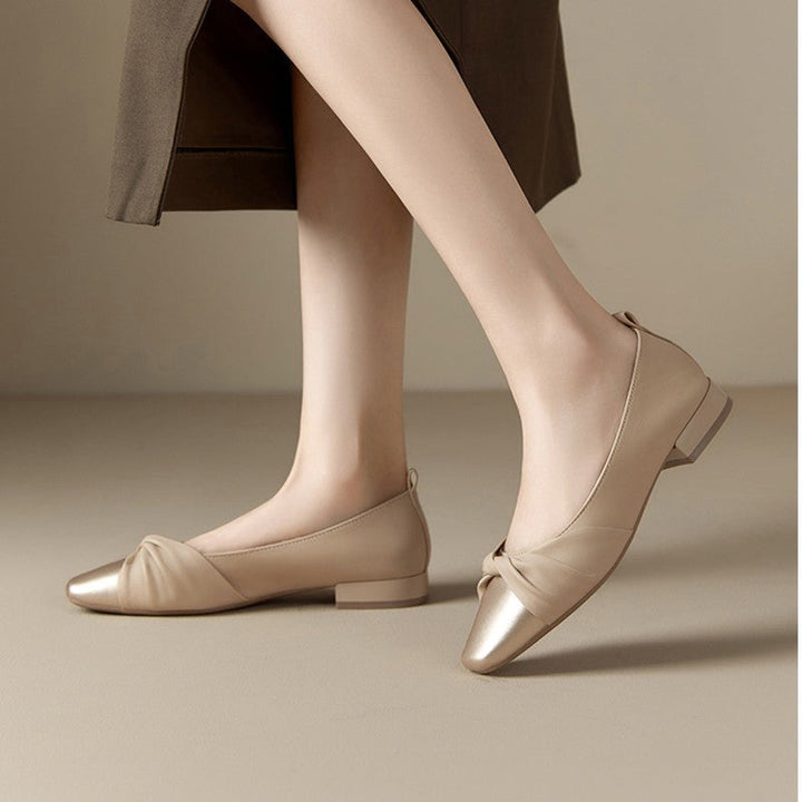 Elegant women's low heel shoes in soft leather with chic pointed toe and twisted strap design, perfect for any occasion.